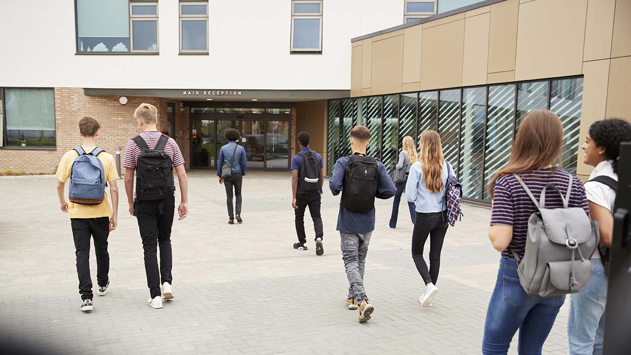 Students walking toward school door